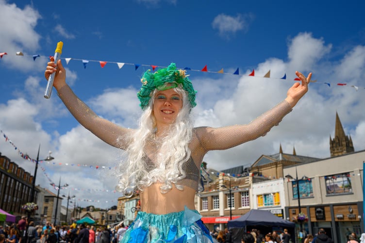 A stilt walker at Children's Day, Truro