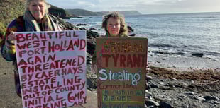 Protesters celebrate after they stop ANPR car park at popular beach