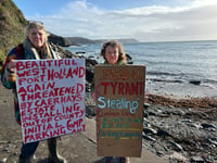 Protesters celebrate after they stop ANPR car park at popular beach