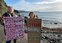 Protesters celebrate after they stop ANPR car park at popular beach