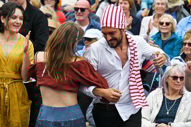 FALMOUTH, CORNWALL - JUNE 15TH 2025 : The 2025 Falmouth International Sea Shanty Festival. The crowd enjoy the last performance of the year on the Seasalt Stage in Events Square by The Oggymen. Photographed by Hugh Hastings of Wonderland for Falmouth Town Council.