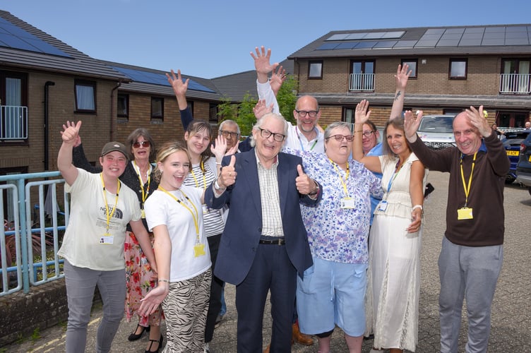 Residents and volunteers from
Miners Court gather with staff to mark the completion of the solar panel
project.