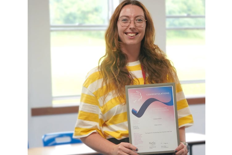Teacher Elizabeth Allday with her certificate of excellence