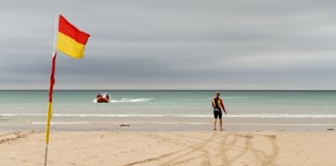 RNLI lifeguards patrolling beach rescue swimmer