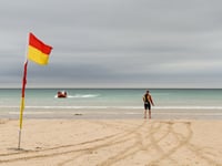 RNLI lifeguards patrolling beach rescue swimmer
