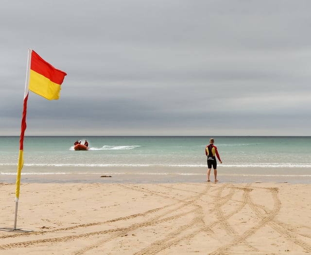 RNLI lifeguards patrolling beach rescue swimmer