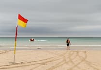 RNLI lifeguards patrolling beach rescue swimmer