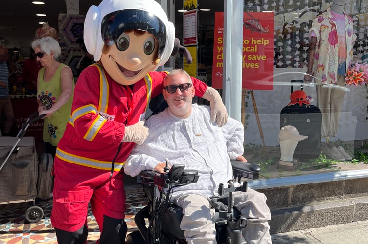 Cornwall Air Ambulance mascot Aircrew Andy with Cllr Steven Webb at the new Truro store