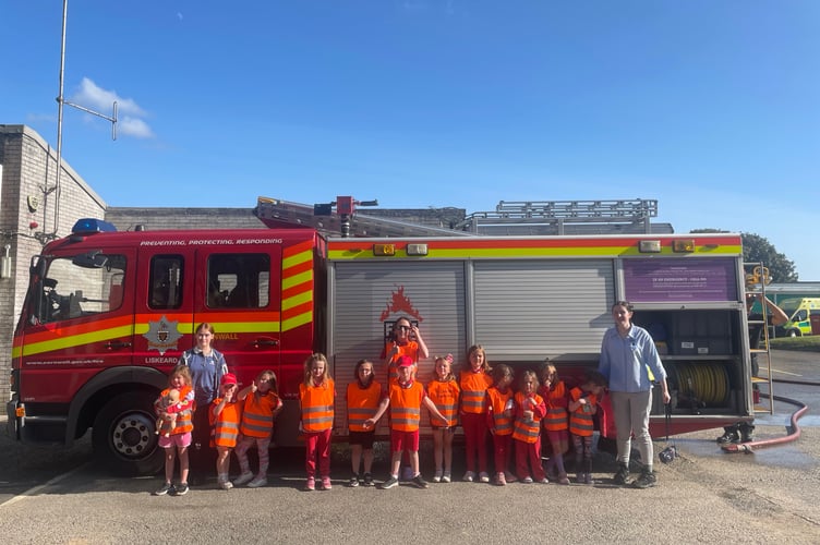The 1st Liskeard Rainbows are all smiles following their visit to the town's fire station