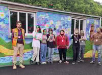 Students creating mural artwork at docks