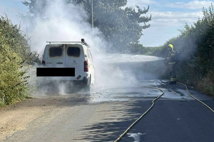 A firefighter from Mevagissey tackling the van fire. (Picture: Mevagissey Community Fire Station)