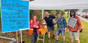 Community unites despite downpour as strike action continues at school