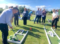 Business club members putt as well as pitch at networking event