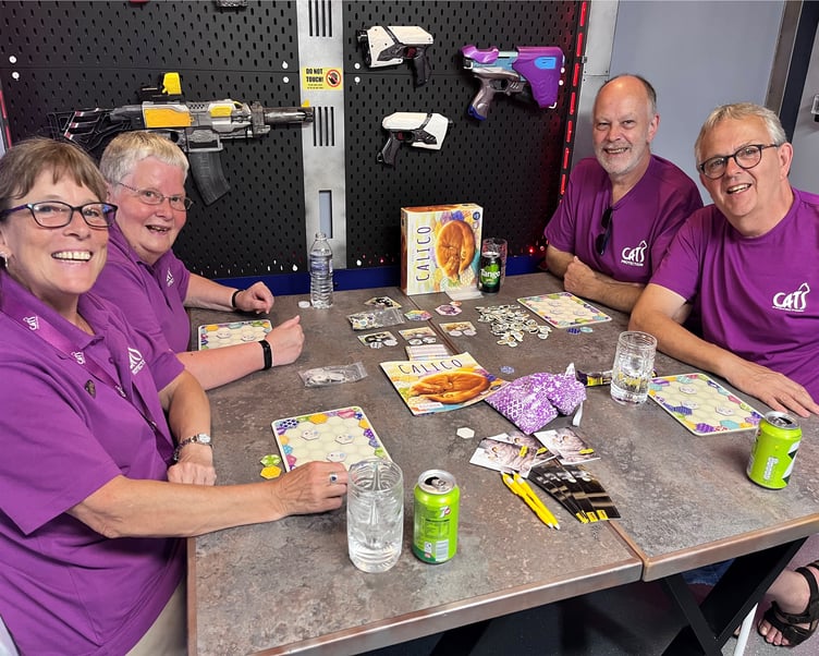 The Cats Protection team playing Calico at Happy Piranha cafe