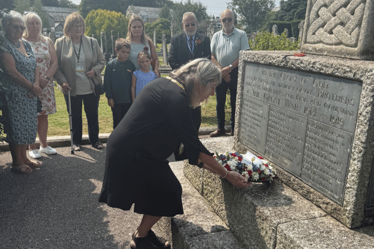 Parish councillors, residents and chair Julie Broad laying wreath at St Stephen war memorial.