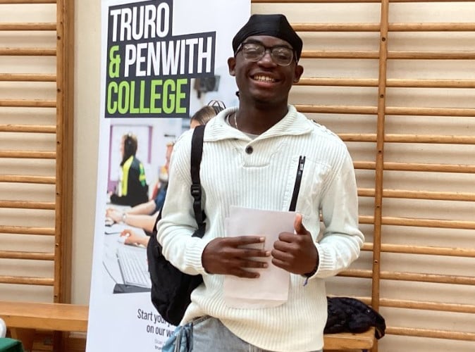 Akiri celebrates his GCSE results at Pool Academy