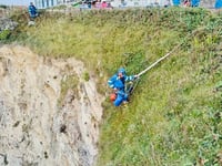 Two people winched to safety after being cut off by Erin swell
