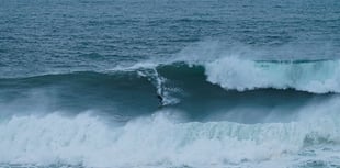 Surfers tackle huge waves generated by hurricane Erin