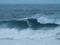 Surfers tackle huge waves generated by hurricane Erin