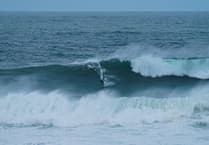 Surfers tackle huge waves generated by hurricane Erin