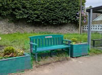 New bench and planters at bus stop outside railway station