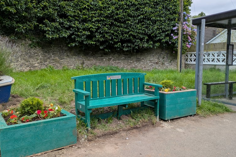 The new bench and planters at the bus stop.
