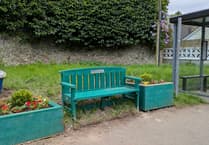 New bench and planters at bus stop outside railway station in Cornwall