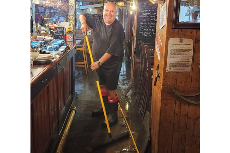 The clean-up gets under way in Mevagissey. (Picture: James Mustoe)