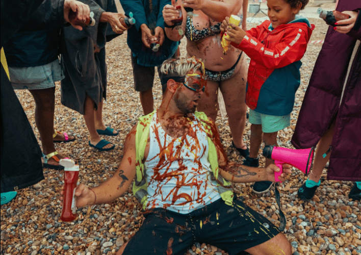 Graham Cullis covered in condiments at Sennen Beach