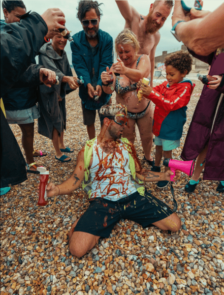 Graham Cullis covered in condiments at Sennen Beach