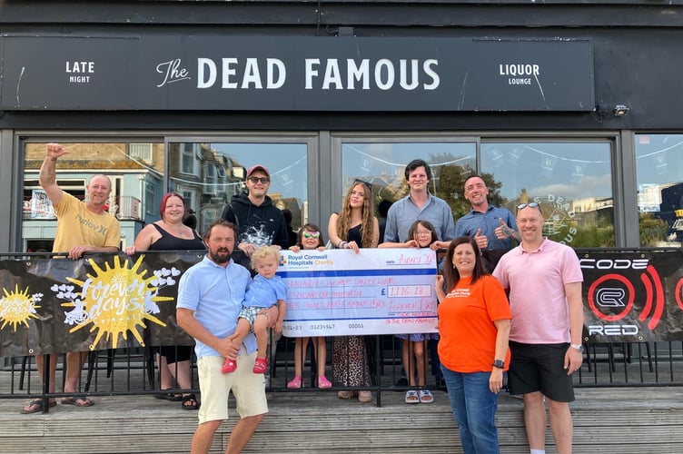Amy Aucott from the Royal Cornwall Hospital in the red top receiving the latest funds from the Forever Days charity