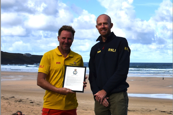 (L-R) Steve Hardy being presented with his medical award by regional lifeguard lead Guy Botterill (Picture: Newquay RNLI lifeguards)