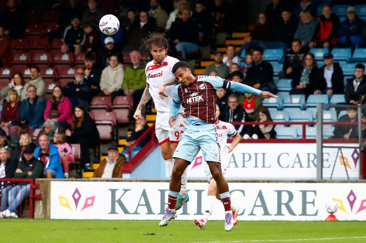 Tyler Harvey of Truro City wins a header against Joe Starbuck of Scunthorpe United during the Enterprise National League match between Scunthorpe United and Truro City at The Attis Arena on 20 September 2025 in Scunthorpe, England (Photo by Steve Taylor/PPAUK)