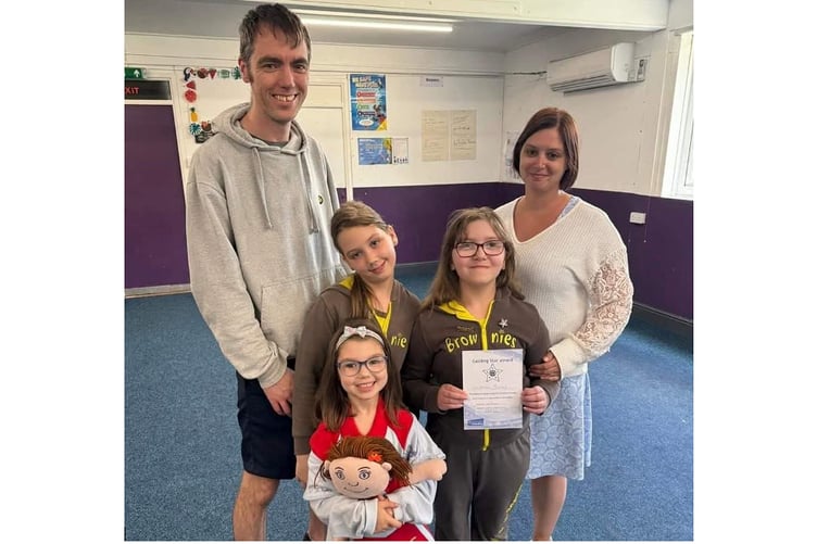 Lowenna Banks holding her Guiding Star award with her family.