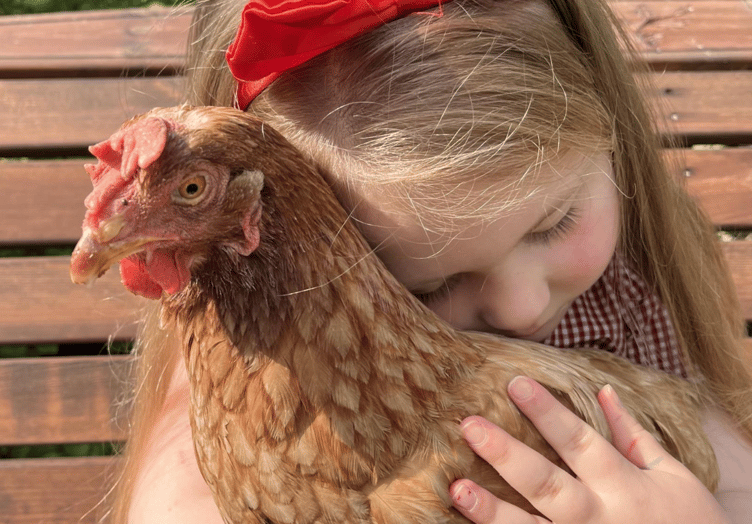 Poppy, five, and adopted hen Veronica