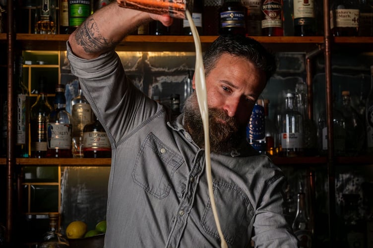 Jamie Garfield, the owner of TomThumb, mixing one of the venue's renowned cocktails