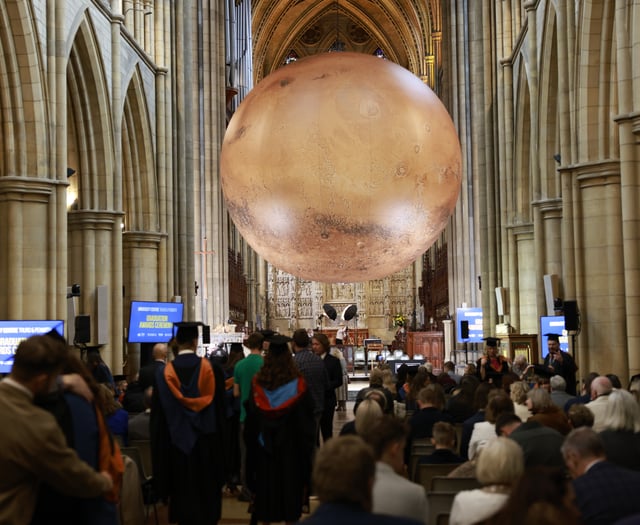 Graduates celebrate under Mars replica
