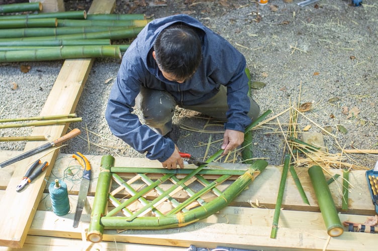 Expert in Japanese bamboo crafting Akihiro Mashimo at Trebah Garden, near Falmouth.Japanese artists travelled to the UK to work with bamboo that grows in a unique Cornish micro-climate. Experts in 'takezaiku' ventured thousands of miles to demonstrate their skills in a plantation at Trebah Garden, near Falmouth.The centuries-old Japanese art translates to "bamboo craft" in English.Over the last 10 years, Trebah Gardens has started to produce some of the largest bamboo canes n the UK because of its unique micro-climate.The 190-year-old sub-tropical garden contains the ideal conditions for growing bamboo, tree ferns, palm trees and magnolias throughout its 26-acre valley.