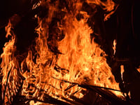 Firefighters tackle bonfire spreading to a boat