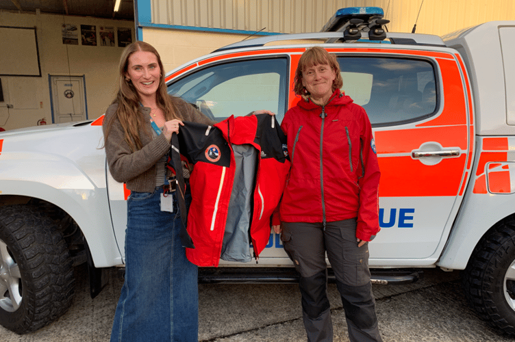 St Austell Brewery’s Procurement Manager Laura Murphy (left) presenting the jackets alongside a member of the West Cornwall Search & Rescue Team.