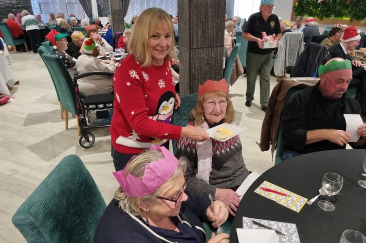 Lions secretary Heather Stanley serves the mince pies and clotted cream at the 2024 Christmas Lunch