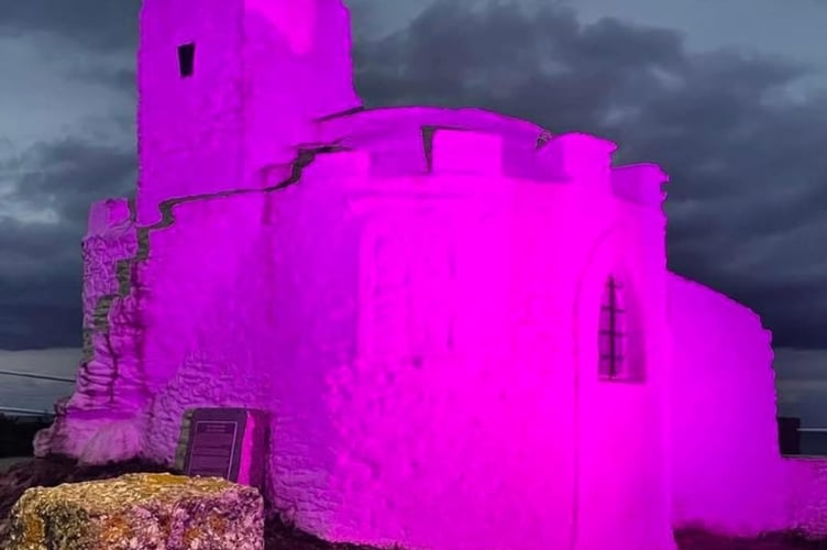 Zoe Dixon at the Huer's Hut with a photograph of her late husband Terry