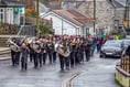 Remembrance parade in village contends with heavy rain and wind