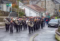 Remembrance parade in Cornish village contends with heavy rain and wind