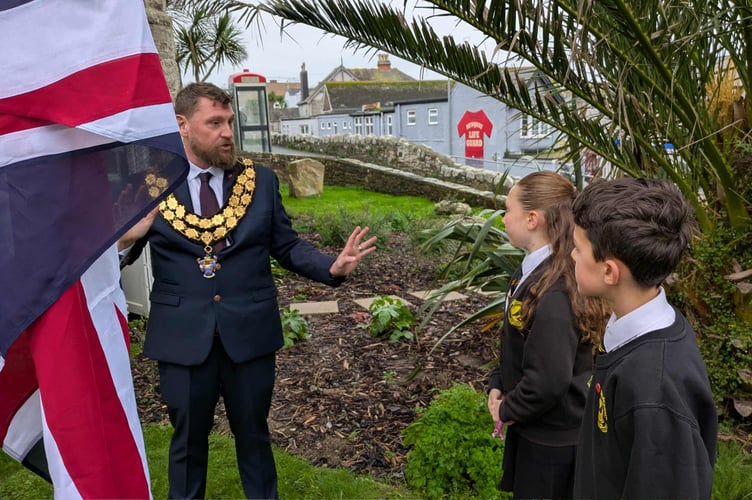 Mayor Cllr Drew Creek showing the ropes to demonstrate how to raise the flag (Picture: Warren Wilkins)