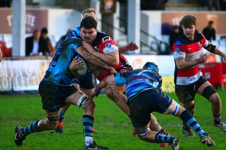 Man of the match Joe Best takes on a solid Tiverton defence.