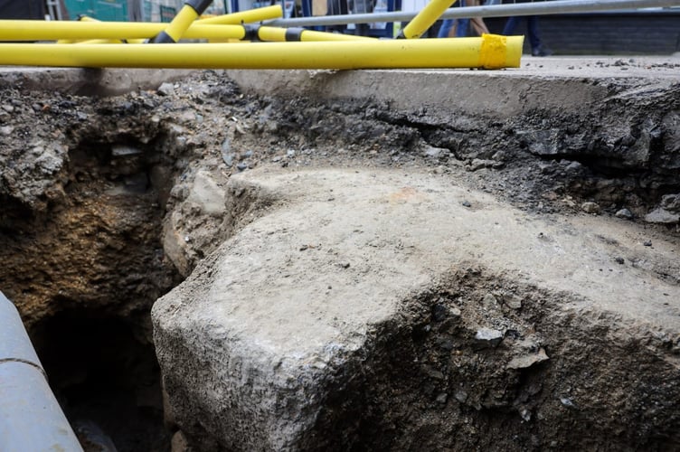 The Borough Cross in Greenmarket, Penzance. A huge piece of Cornish history dating back to the 18th century has been unexpectedly uncovered - during road works.Workers for Wales & West Utilities made the discovery while carrying out excavations for a gas pipes replacement in Greenmarket, Penzance this week.Photos show the workmen gathered around a large granite cross, buried beneath the road's surface.Spotted by local historian and author Linda Camidge, the granite cross buried beneath the road surface marks the historic centre of Penzance.