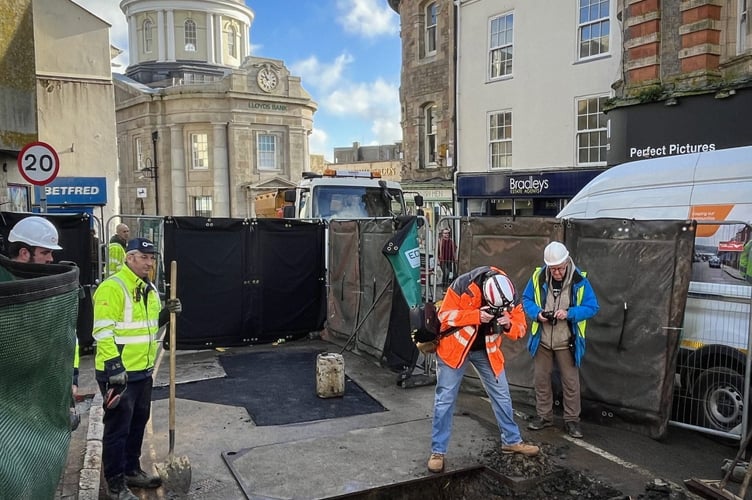 The Borough Cross in Greenmarket, Penzance. A huge piece of Cornish history dating back to the 18th century has been unexpectedly uncovered - during road works.Workers for Wales & West Utilities made the discovery while carrying out excavations for a gas pipes replacement in Greenmarket, Penzance this week.Photos show the workmen gathered around a large granite cross, buried beneath the road's surface.Spotted by local historian and author Linda Camidge, the granite cross buried beneath the road surface marks the historic centre of Penzance.