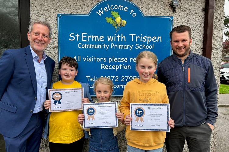 Mark Docherty from Legacy Properties and Jamie Cameron, assistant head teacher of St Erme with Trispen primary school, present the children with their certificates