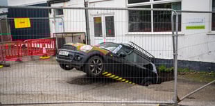 Officials still trying to figure out how to move car from sink hole